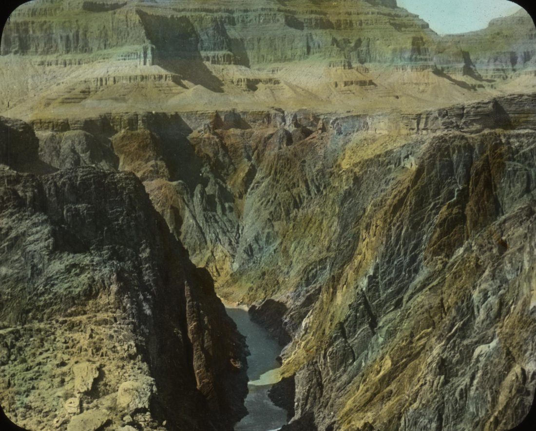 The Grand Canyon, with bold horizontal bands of sedimentary rock strata in its walls above the Colorado River.